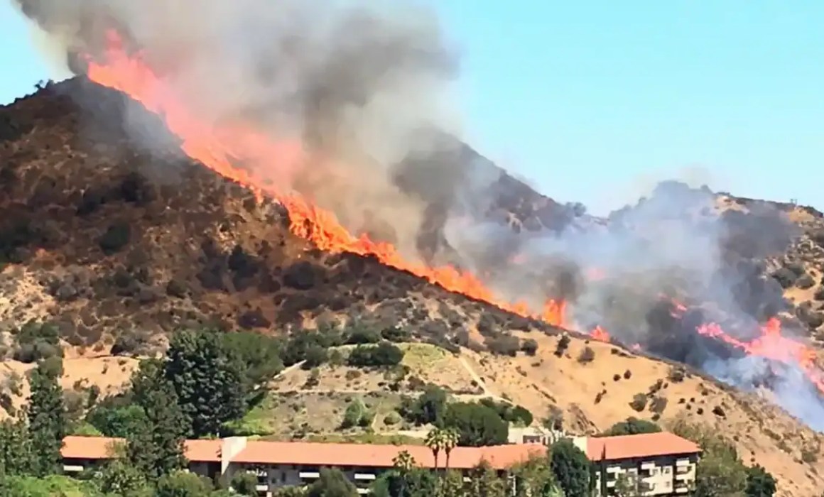 Helicopters dumping water on the fire